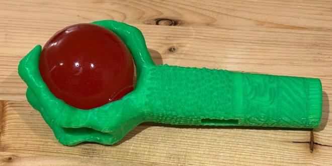 Claw printed in green PLA, with a red ball